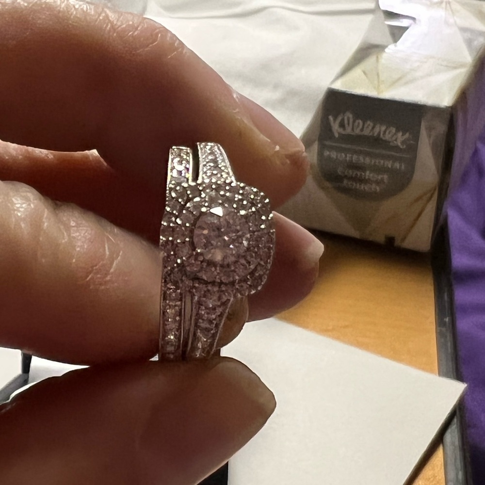 14k wg. 1 ctw. Center stone 1/3c. Has a lifetime warranty. Asking 2000 OBRO